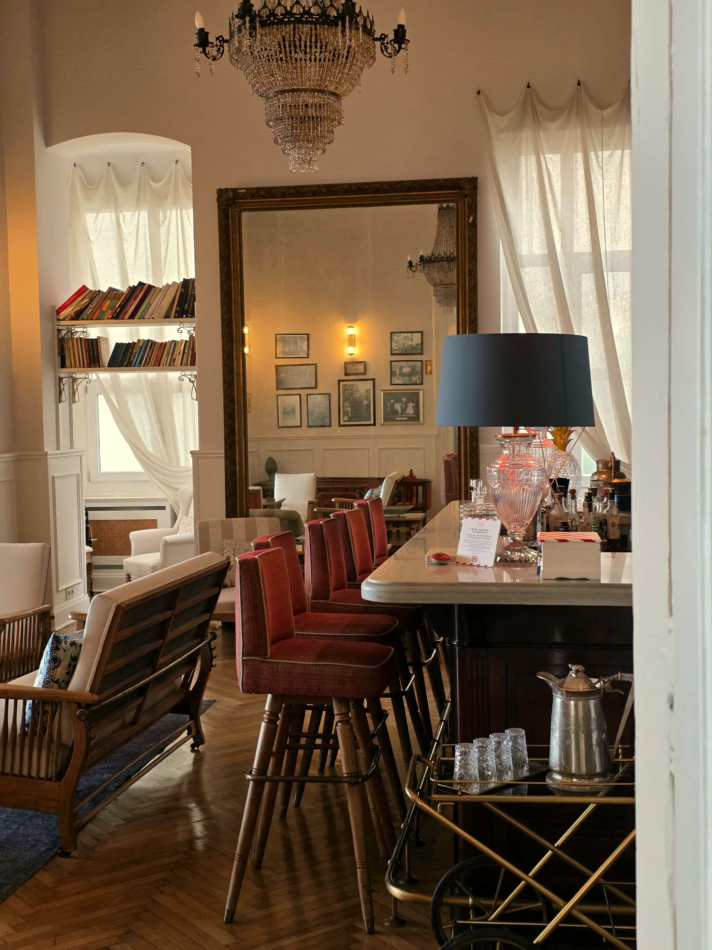 Vintage hotel bar lounge with warm lamplight and dark timber