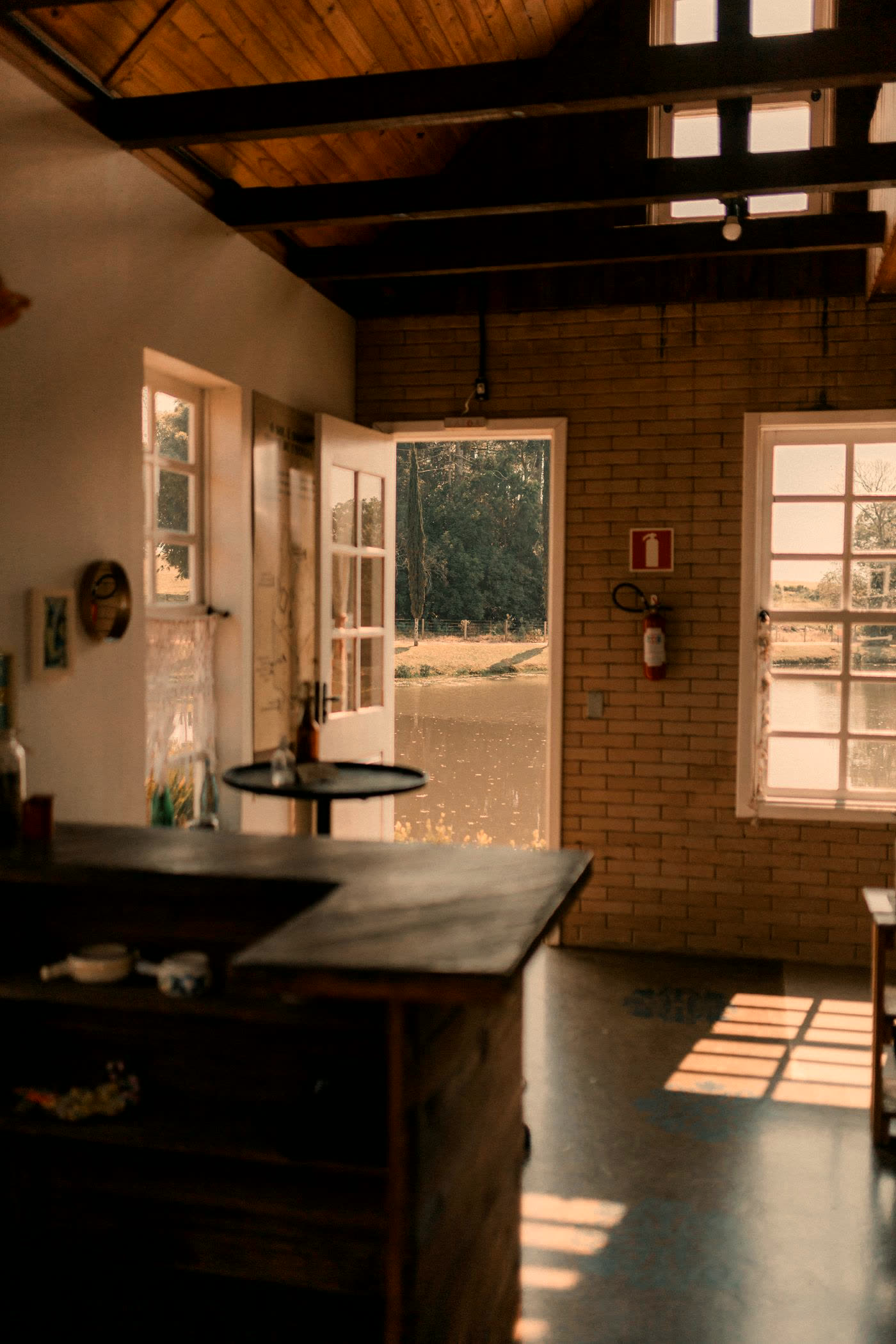 Rustic wooden interior with doors opening onto a wooded view